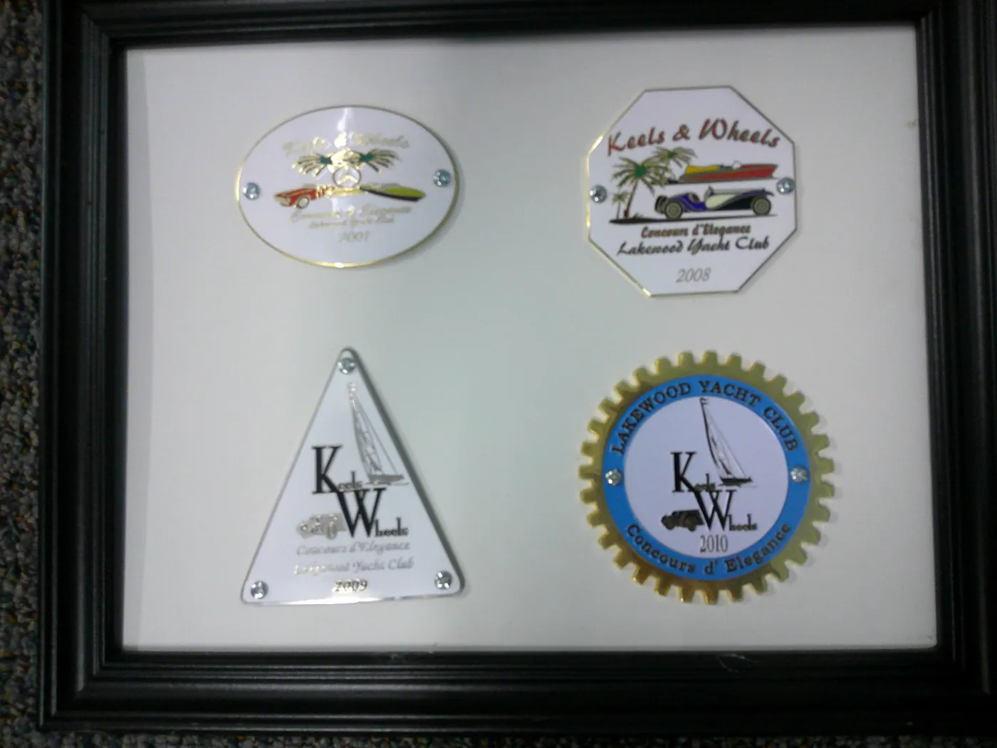 Framed Keels & Wheels Concours d'Elegance dash badges from 2007 through 2010.