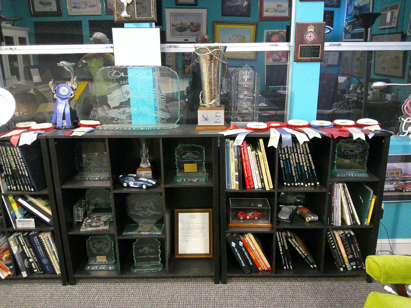 Shelves of concours trophies, glass awards and ribbons in the Auto Collectors Garage office.